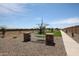 Well-maintained community walking path featuring desert landscaping, stone pillars, a white fence, and distant views at 848 W Riparian Dr, San Tan Valley, AZ 85140