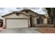 Inviting single-story home featuring a two-car garage and classic desert landscaping at 8582 W Rue De Lamour --, Peoria, AZ 85381