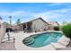 Inviting backyard pool with a patio featuring outdoor seating, a rock surround, and the home's exterior at 8948 W Fargo Dr, Peoria, AZ 85382