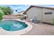 Beautiful backyard pool with rock surround, patio, and view of the home's exterior at 8948 W Fargo Dr, Peoria, AZ 85382