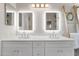 Modern bathroom features double sinks, marble countertops, illuminated mirrors and decorative fixtures at 8948 W Fargo Dr, Peoria, AZ 85382