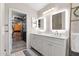 Bright bathroom featuring a double sink vanity with ample storage space and walk-in closet at 8948 W Fargo Dr, Peoria, AZ 85382