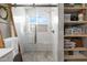 Modern bathroom featuring a glass-enclosed shower with bench seating and tiled walls and storage shelves at 8948 W Fargo Dr, Peoria, AZ 85382