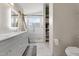 Bright bathroom featuring double sink vanity with marble countertops, glass-enclosed shower, and ample storage at 8948 W Fargo Dr, Peoria, AZ 85382