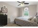 Comfortable bedroom with ceiling fan, neutral walls and unique window at 8948 W Fargo Dr, Peoria, AZ 85382