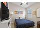 Cozy bedroom features a large bed, ceiling fan and picturesque artwork at 8948 W Fargo Dr, Peoria, AZ 85382