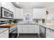 Well-lit kitchen with stainless steel appliances and white cabinets at 8948 W Fargo Dr, Peoria, AZ 85382