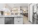 Open-concept kitchen with stone countertops, breakfast bar and stainless steel dishwasher at 8948 W Fargo Dr, Peoria, AZ 85382
