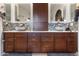 Bathroom featuring double sinks, a center cabinet, and decorative backsplash at 13313 W Indianola Ave, Litchfield Park, AZ 85340