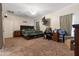 Large bedroom with neutral carpet and a dark wood bed frame and matching side tables at 13313 W Indianola Ave, Litchfield Park, AZ 85340