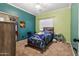 Bedroom with blue and green walls, carpet, and a ceiling fan at 13313 W Indianola Ave, Litchfield Park, AZ 85340