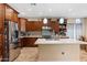 Bright kitchen featuring stainless appliances, an island with seating, and tiled backsplash at 13313 W Indianola Ave, Litchfield Park, AZ 85340