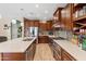 Spacious kitchen with stainless steel appliances, center island, tile backsplash, and plenty of counter space at 13313 W Indianola Ave, Litchfield Park, AZ 85340