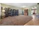 Spacious living room featuring neutral paint, carpet, and tile flooring with ample natural light at 13313 W Indianola Ave, Litchfield Park, AZ 85340