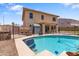 Backyard pool with fencing, landscaping, and two story home at 13313 W Indianola Ave, Litchfield Park, AZ 85340
