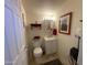 Compact half bath with vanity, storage, and decorative shelving for added convenience at 1426 S Havasupai Dr, Apache Junction, AZ 85119