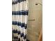 Bathroom featuring a shower/tub combo with blue striped shower curtain and safety bars at 1426 S Havasupai Dr, Apache Junction, AZ 85119