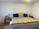 Bedroom featuring a large bed with throw pillows and a yellow accent blanket at 1426 S Havasupai Dr, Apache Junction, AZ 85119