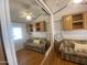 Bright bedroom with wood floors, built-in cabinets, and a comfortable-looking sofa at 1426 S Havasupai Dr, Apache Junction, AZ 85119