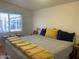 Bedroom featuring a large bed with throw pillows and a window with bright sunlight at 1426 S Havasupai Dr, Apache Junction, AZ 85119