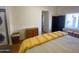 Bright bedroom featuring laundry units and a dresser with neutral decor at 1426 S Havasupai Dr, Apache Junction, AZ 85119