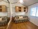Bright bedroom with wood floors, built-in cabinets, and a comfortable-looking sofa at 1426 S Havasupai Dr, Apache Junction, AZ 85119