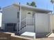 Exterior view of a well-maintained home with white stairs and desert landscaping at 1426 S Havasupai Dr, Apache Junction, AZ 85119