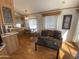 Cozy living room with wood floors, patterned sofa, and natural light from a window at 1426 S Havasupai Dr, Apache Junction, AZ 85119