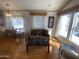 The living room offers natural light, wood flooring, and comfortable seating at 1426 S Havasupai Dr, Apache Junction, AZ 85119