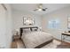 Staged main bedroom with a large bed, modern decor, and a ceiling fan at 1453 W Birch Rd, San Tan Valley, AZ 85140