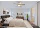 Staged main bedroom with modern furnishings, neutral walls, carpet, and a ceiling fan at 1453 W Birch Rd, San Tan Valley, AZ 85140