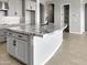 Kitchen island with granite countertop, undermount sink, pendant lighting, and shaker cabinets at 15787 W Mariposa Grande St, Surprise, AZ 85387