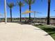 Relaxing community pool with desert landscaping including palm trees and shaded lounge chairs at 15787 W Mariposa Grande St, Surprise, AZ 85387