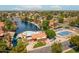 An aerial view of lakeside amenities, featuring a community pool, tennis courts, and lush landscaping at 1601 E Cindy St, Chandler, AZ 85225