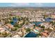 An aerial view showcases a community with lake, pools, tennis courts, and well-manicured green landscape at 1601 E Cindy St, Chandler, AZ 85225