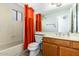 Bathroom with a tub and shower combination and vibrant orange curtain at 1601 E Cindy St, Chandler, AZ 85225