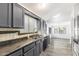 Well-lit kitchen with stainless steel appliances, gray cabinetry, and stylish backsplash at 1601 E Cindy St, Chandler, AZ 85225