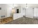 The living room boasts hard flooring and neutral walls leading to a view of an entryway with brick flooring at 1601 E Cindy St, Chandler, AZ 85225