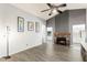 Inviting living room with a fireplace, ceiling fan, and modern floors perfect for relaxation at 1601 E Cindy St, Chandler, AZ 85225