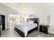 Serene main bedroom with hardwood floors, a large bed, and an en-suite bathroom at 1601 E Cindy St, Chandler, AZ 85225