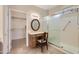Bright bathroom featuring a glass-enclosed shower and a vanity area with a chair, creating a spa-like atmosphere at 17009 W Eureka Springs Dr, Surprise, AZ 85387