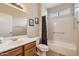 Bright bathroom featuring a single sink vanity, framed art, and a shower-tub combination at 17009 W Eureka Springs Dr, Surprise, AZ 85387