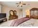 Comfortable bedroom with neutral tones, a spacious dresser, and a view into the en-suite bathroom, creating a private oasis at 17009 W Eureka Springs Dr, Surprise, AZ 85387