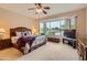 Relaxing bedroom with a large window, ceiling fan, and comfortable bedding, offering a peaceful retreat at 17009 W Eureka Springs Dr, Surprise, AZ 85387