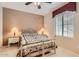 Cozy bedroom featuring soft neutral tones and a decorative white metal bed frame at 17009 W Eureka Springs Dr, Surprise, AZ 85387