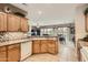 Bright kitchen featuring oak cabinets, mosaic backsplash, and stainless appliances, offering a functional and stylish cooking space at 17009 W Eureka Springs Dr, Surprise, AZ 85387