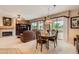 Open concept living area with a fireplace, adjacent to dining area and large sliding doors to outdoors at 17009 W Eureka Springs Dr, Surprise, AZ 85387