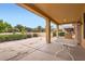 Covered patio area perfect for outdoor dining and relaxation overlooking lush landscaping at 17009 W Eureka Springs Dr, Surprise, AZ 85387