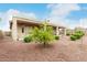 Backyard with patio, landscaped rock garden and mature lemon tree, offering a peaceful retreat at 18247 N 168Th Cir, Surprise, AZ 85374