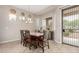 Bright dining area featuring tile floors, natural light, and direct access to the backyard patio at 18247 N 168Th Cir, Surprise, AZ 85374